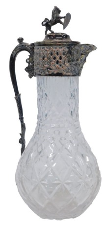 A Victorian pressed glass and silver plated claret jug, the hinged lid with applied rearing lion and crest thumb piece, 2cm high.