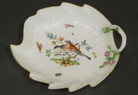 A Meissen porcelain leaf shaped dish, decorated with birds on a branch, insects, etc., with stylised handle, blue cross swords mark to underside, 21.5cm wide.