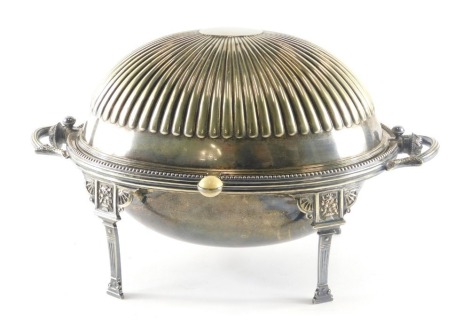 A late 19th/early 20thC silver plated breakfast dish, with the domed gadrooned top hinged to enclose an oval interior with grill on reeded legs, with floral brackets, 37cm wide.