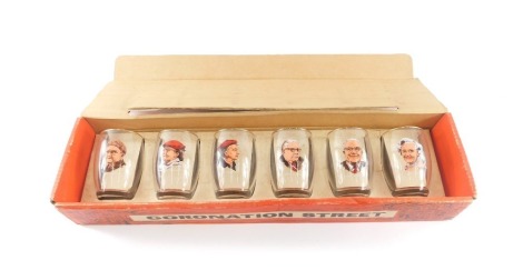 A set of six vintage 1960s Coronation Street glasses, each with printed image of character, in original box.