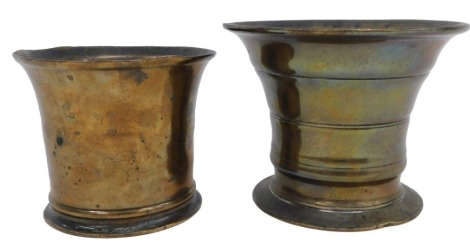 An 18th or 19thC bell metal mortar, with moulded design, 9cm high, and a plain example, 8cm high. (AF)