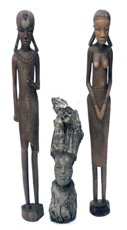 A pair of African tribal figures, modelled in the form of a gentleman and lady, 132cm high (AF) and an African tribal rustic carving of a male bust, 80cm high. (3)