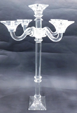 A large cut glass five branch candelabra, with faceted stem and tapering square foot, in the manner of Baccarat, 80cm high, 48cm wide.