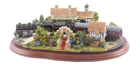 A large Lilliput Lane model of The Royal Train at Sandringham, on a shaped mahogany base, 32cm long.