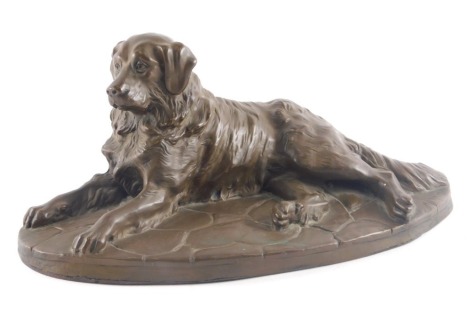 A bronzed resin sculpture of a recumbent golden retriever, unsigned, 25.5cm wide.