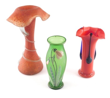 A collection of art glass, to include a red mottled glass vase, with fold over rim and decorated with a leaf, a green frosted glass vase with applied Art Nouveau style enamel tulip or crocus, and a red vase. (3)