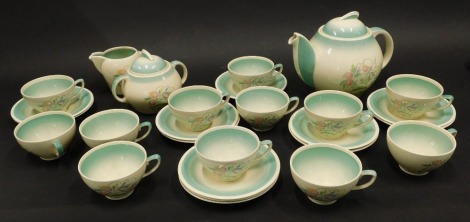 A Susie Cooper flower printed part tea service, the teapot with kestrel beak spout, to include cups, saucers, milk jug, and covered sugar bowl.