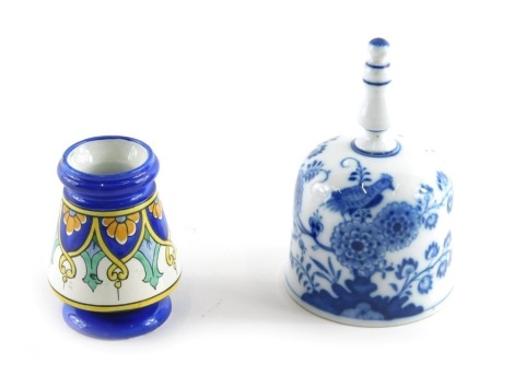 A late Meissen porcelain bell, decorated with a bird, flowers, etc., blue cross swords mark to underside and indistinct number, 11cm high, and a small French ceramic vase decorated with Islamic style bands, 7cm high.