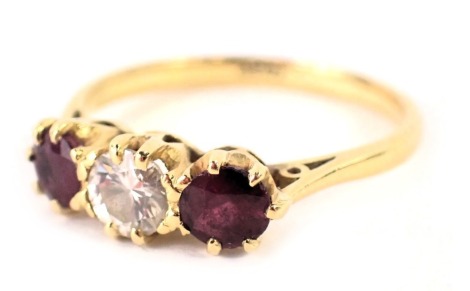 A dress ring with two rubies and a central diamond, each in claw setting, diamond approximately 0.28ct flanked by two similar sized rubies, yellow metal stamped 18ct, ring size P½, 3.2g all in.