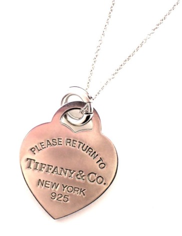 A Tiffany & Co pendant and chain, the heart shaped pendant inscribed 'Please return to Tiffany and Co New York' and stamped 925, 9.8g all in, boxed.