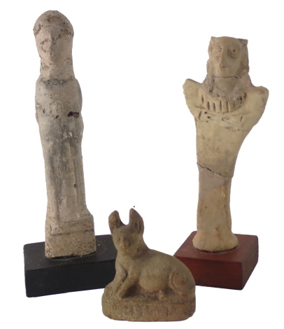 Three ancient figures, comprising an Egyptian figure of Anubis, a Syrro Hittite bird headed figure and a figure of Tanit, the smallest 7cm high. (3)