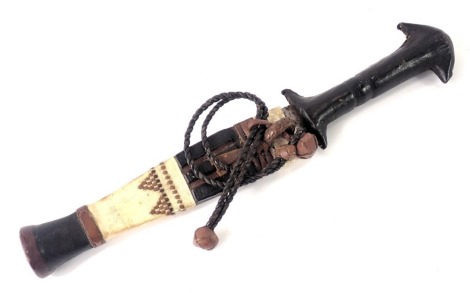 An African tribal dagger, with leather scabbard and handle, 27cm long.