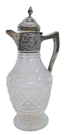 A late Victorian silver and cut glass claret jug, with acorn finial top, on hinged lid with floral embossed rim and shaped handle, on a stepped pressed glass foot, Birmingham 1898, by Plante and Co, 29cm high.