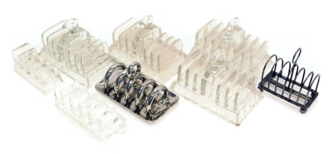 Various pressed glass toast racks, silver plated toast rack, and a silvered pottery toast rack.