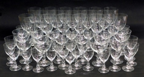 A large part suite of plain glasses with baluster stems, various sizes.