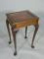 A rectangular mahogany display table on carved cabriole legs and padded feet