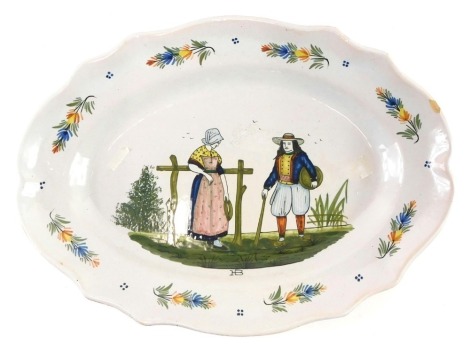 A 19thC Quimper Faience platter, decorated with male and female figures, signed HB to front, impressed number 24 to reverse, 31cm wide.