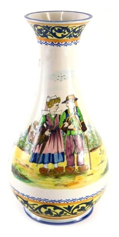 A 1930s HB Quimper Faience vase, decorated with figures wearing clogs, flowers, etc., in the manner of Paul Fouillen, 36cm high.