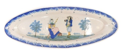 A large 19thC Quimper oval platter, decorated with a lady sewing and gentleman playing a musical instrument, HB stamp in blue to underside, 61cm wide.