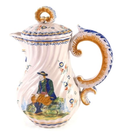 An early 20thC HR Quimper Faience teapot, decorated with seated figure and lady, within floral borders, on a pink ground, 23cm high.