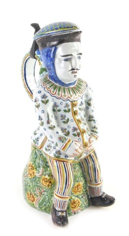 A 19thC large Faience Toby jug by Fourmaintraux Courquin, made in Desvres Northern France, decorated overall with leaves, scrolls, etc., and with a metal hinge, 31cm high.