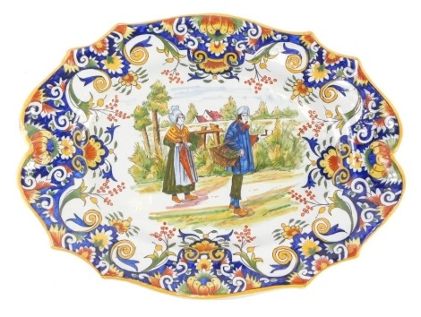 A 19thC Fourmaintraux Freres oval plaque, decorated with figures holding a basket within a foliate scroll and flower border, 36cm diameter.