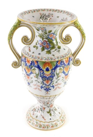 A 19thC Fourmaintraux Freres two handled Faience vase, decorated with flowers, scrolls, leaves, etc., 35cm high.