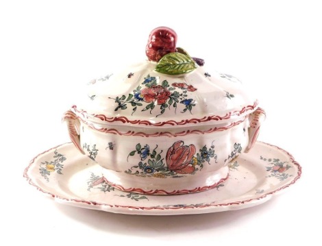 A 19thC Pouplard Beatrix Malicorne faience tureen, cover and under plate, each polychrome decorated in a pink, red and blue decoration, the tureen 28cm diameter, the plate 42cm diameter.