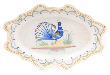 A late 19th/early 20thC Faience shaped platter or meat dish, decorated with a peacock, on a pink ground, unmarked, 37cm wide.