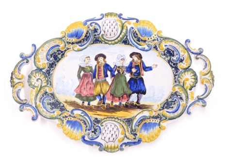 A 19thC Formaintraux Courquin two handled Faience plate of plaque, decorated with four figures within elaborate scrolling borders, 41cm wide.