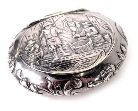 A continental white metal trinket box, of oval design with an embossed detail of fisherman, and scroll border stamped sterling 930, 1.78oz.