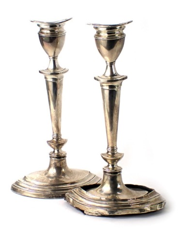 A pair of Edward VII silver candlesticks, each of boat shaped form, with weighted bases, Birmingham 1909, 25cm high. (AF)