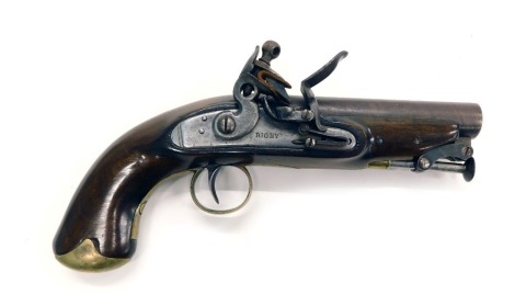 An early 19thC Irish 16-bore flintlock pistol by Rigby, with swivel ram rod, brass trigger guard and pommel to the walnut stock, the lock plate stamped Rigby, Dublin to the barrel and with proof stamp, 25cm long overall.