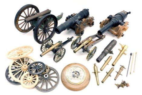 A collection of five model cannons, and various model cannon parts and components, including barrel and various wheels, etc. and an aneroid barometer.