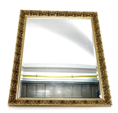 A modern gilt wall mirror, with bevelled plate, 116cm high, 90cm wide.