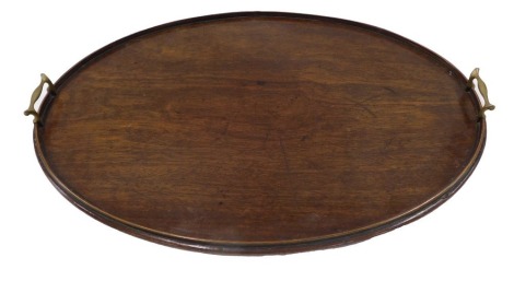 A mahogany oval tray, with shallow gallery and two brass handles, 66cm wide.