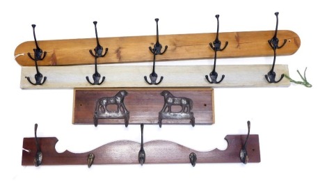 A set of pine and ebonised metal coat hooks, and three other sets, to include a pair mounted with double dog shaped hooks, the largest 99cm wide.