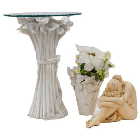 A cream painted resin occasional table, with circular glass top, the base decorated with stylised lilies, 67cm high, 50cm diameter, a cream painted resin vase of flowers, and a composition figure of a seated nude. (3)