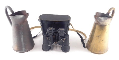 A copper flagon, a brass flagon, and a pair of Cosmica binoculars.