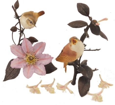 Two Royal Worcester bird ornaments, comprising nightingale on honeysuckle, 22cm high, and wren on clematis, 22cm high. (2, AF)