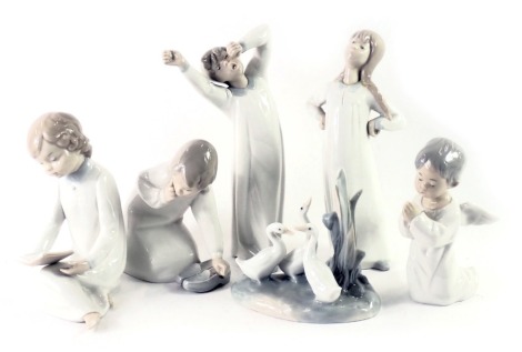 Six Lladro and other figures, comprising four Lladro and two Spanish porcelain, children, geese, and praying figures, the largest 22cm high. (AF)