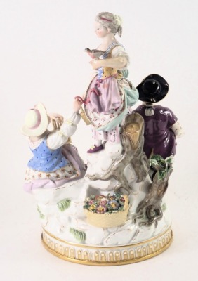A Dresden porcelain figure group, of three figures on stepped stage base, with blue cross sword type mark to underside, 21cm high. (AF) - 2