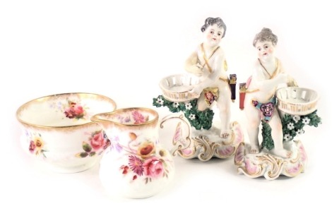 Four items of ceramics, comprising two continental porcelain figures, of children carrying baskets, with gilt and floral decoration, 12cm high, unmarked, and a Hammersley China floral pattern milk jug and sugar bowl. (4)