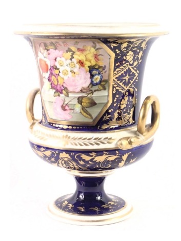 A mid 19thC Derby porcelain two handled urn, painted with flowers within gilt borders on a cobalt blue ground, hand written marks in red, 21cm high.