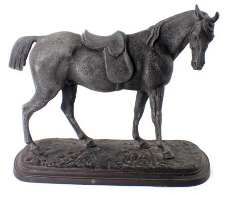 A cast spelter figure of a standing horse, on painted mottled decoration, on oval base, 25cm high. (AF)