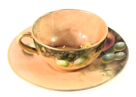 A Royal Worcester miniature cup and saucer, in fruit and grape pattern, bearing indistinct signature, 8cm diameter.