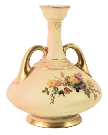 A Royal Worcester blush ivory two handled vase, with gilt handles and painted floral spray with puce Worcester stamp to underside, 16cm high.