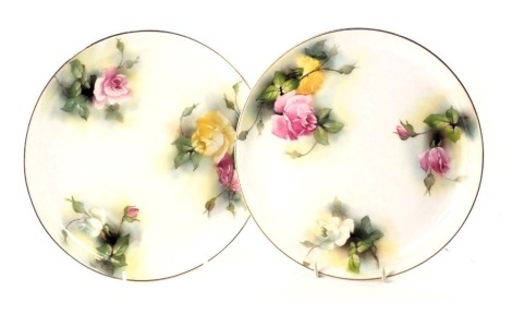 Two Royal Worcester cabinet plates, each with gilt border and painted decoration of pink and yellow roses, 22cm diameter. (2)