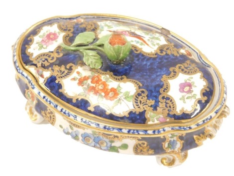 A 19thC porcelain box and cover, in Worcester style, with panels of flowers and an exotic bird, raised registration number, 16cm wide.