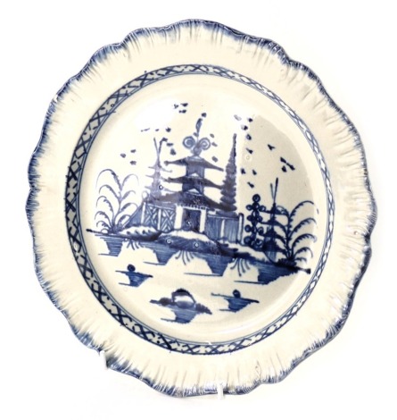 A late 18th/early 19thC pearl ware blue and white cabinet plate, decorated with a central panel of buildings, 23cm diameter.